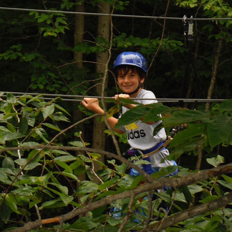 Child participating in the aerial zipline activity.