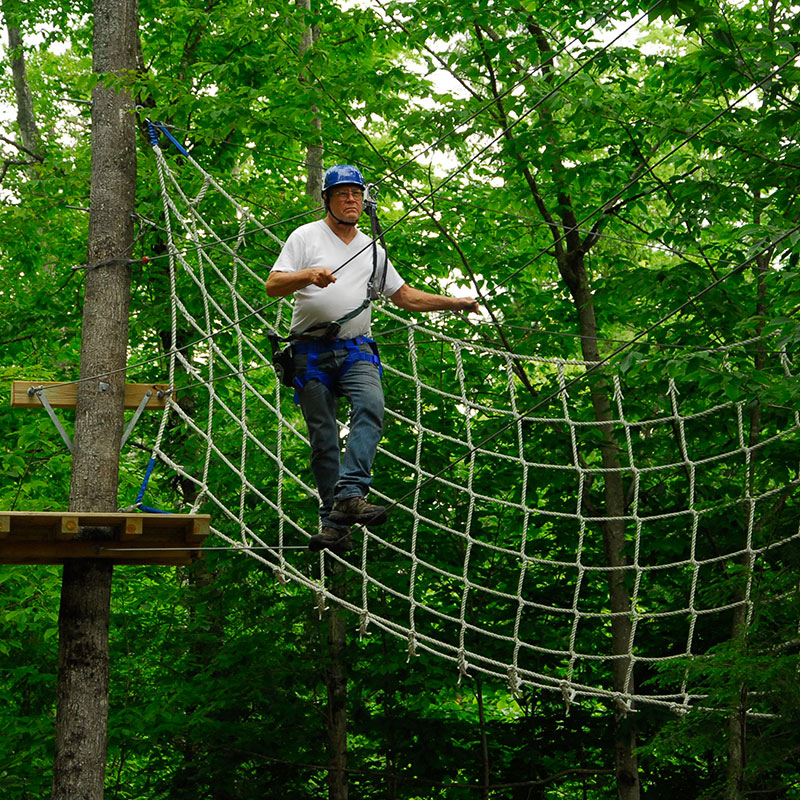 Rope net obstacle in the aerial zipline course.
